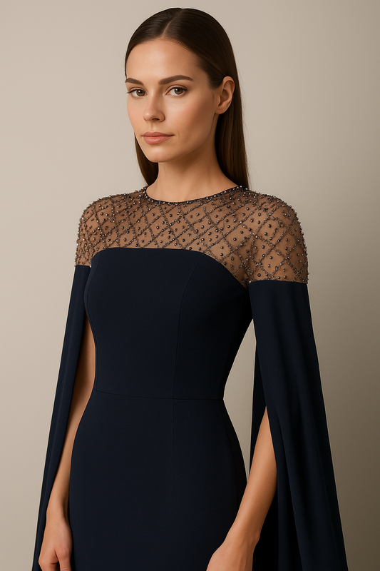Model wearing Jovani 46522 evening gown with sheer beaded neckline, cape sleeves, and fitted silhouette.  Close up view.