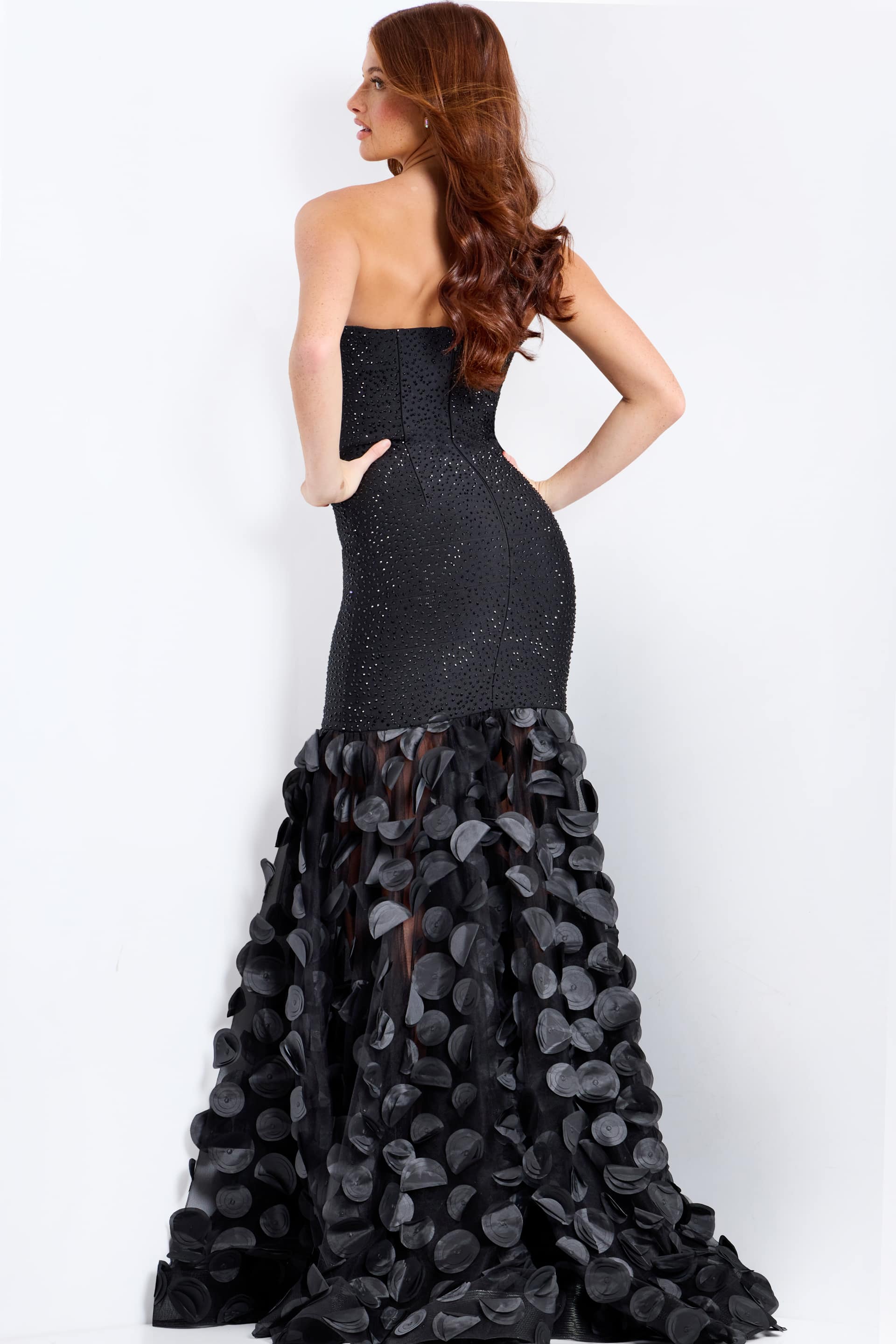 Black strapless gown with floral details on a white background