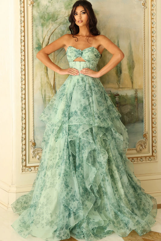 Woman wearing a green strapless gown in front of an ornate mirror.