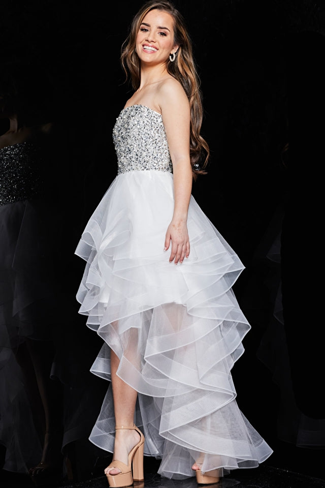 Model wearing Jovani K05916 strapless beaded high-low dress with sparkling bodice and layered ruffle skirt.