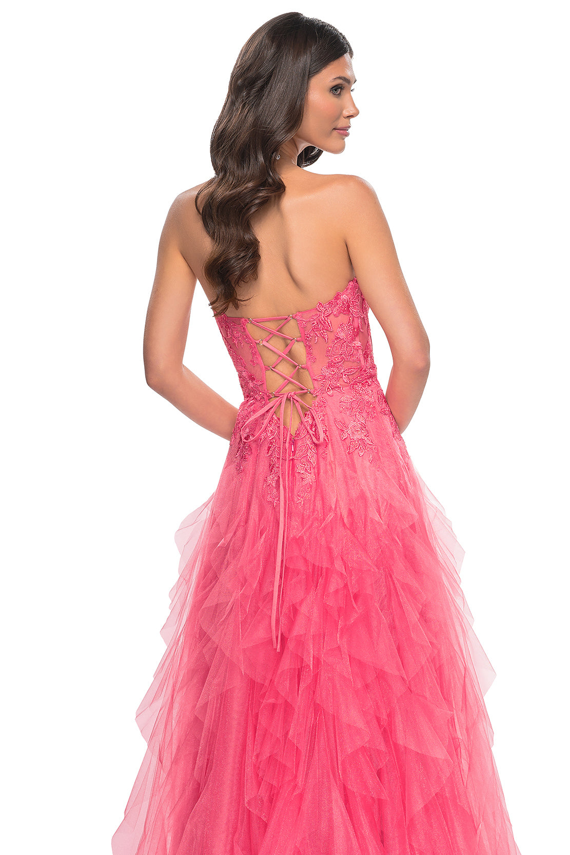 La Femme 32286 Illusion Lace Bustier A-Line Prom Gown - A captivating A-line gown featuring a ruffle tulle skirt, high slit, and illusion lace bustier bodice for a glamorous and sophisticated prom look. The model is wearing the dress in the color coral.  Back View.