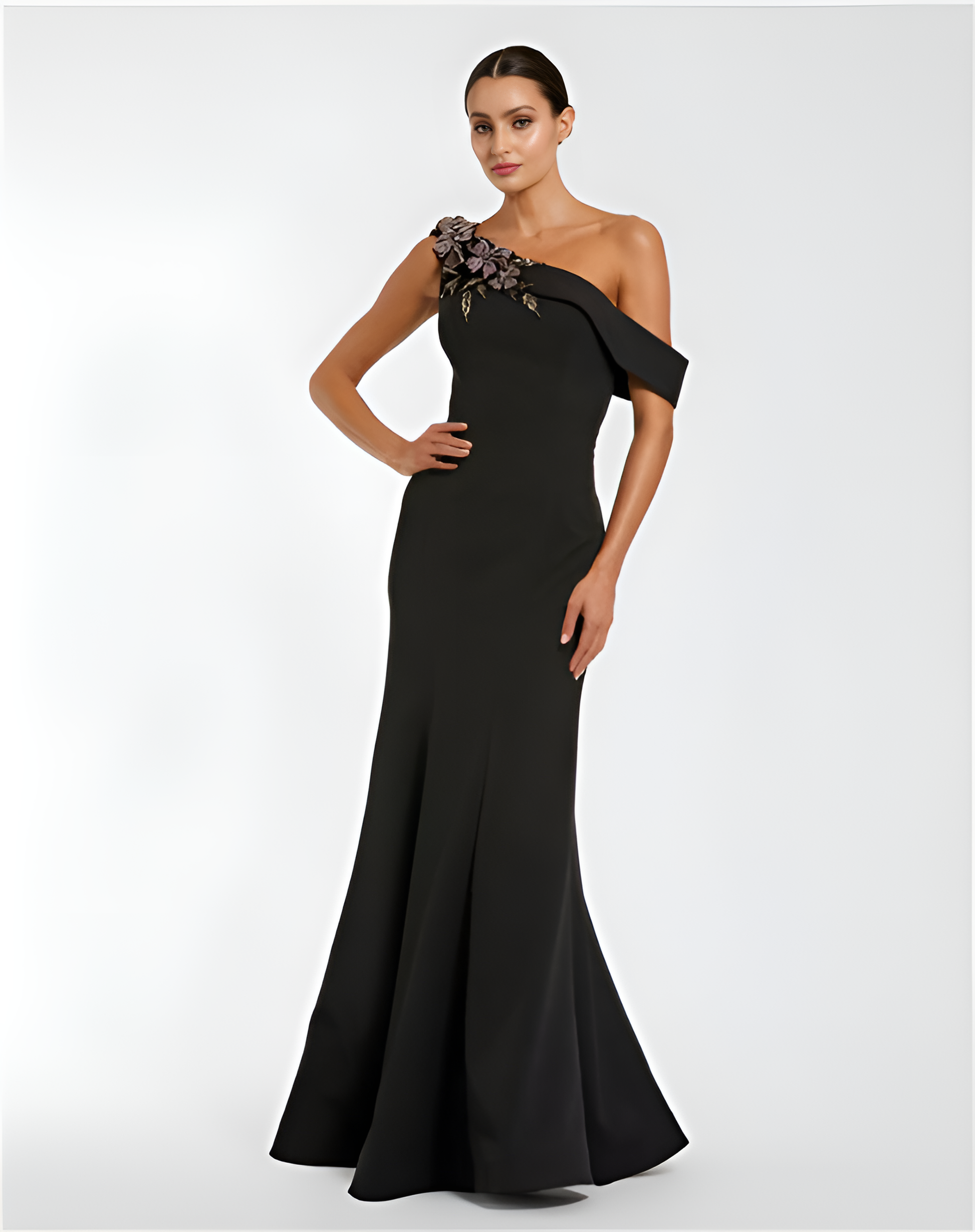 Black one-shoulder evening gown with floral detail on a white background