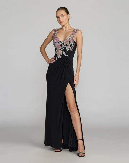 Black evening gown with floral embroidery on a gray background