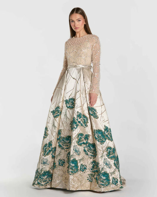 Model wearing Mac Duggal 21182 long-sleeve beaded A-line gown with illusion neckline and brocade skirt.