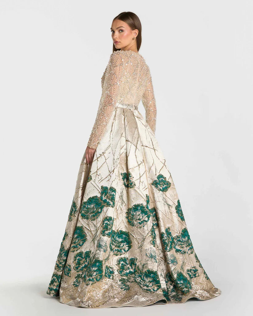 Model wearing Mac Duggal 21182 long-sleeve beaded A-line gown with illusion neckline and brocade skirt.