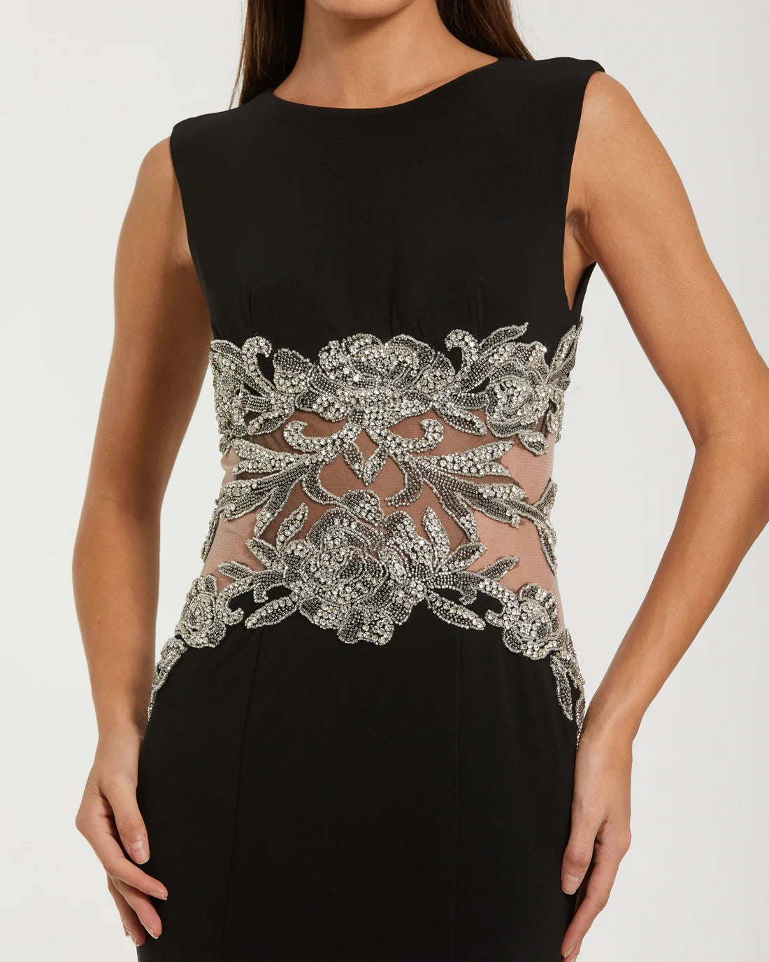 Model wearing Mac Duggal 2324 sleeveless jersey gown with beaded illusion waist detail.