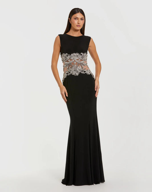 Model wearing Mac Duggal 2324 sleeveless jersey gown with beaded illusion waist detail.