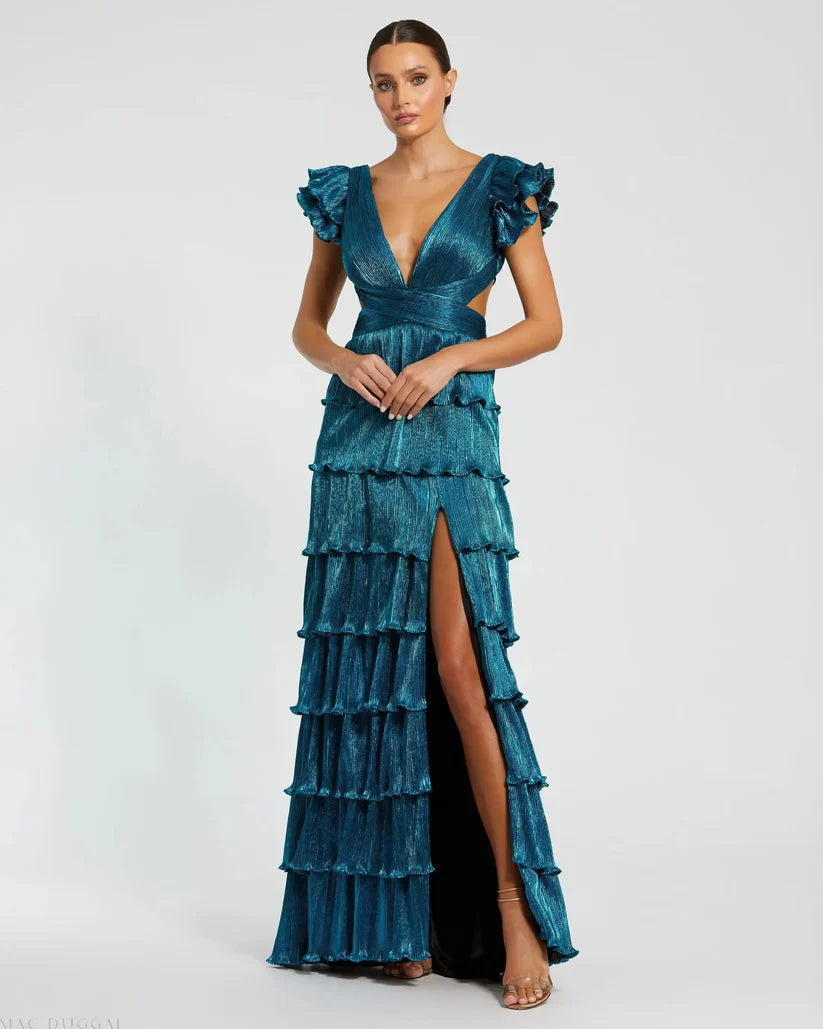 Model wearing Mac Duggal 26740 gown with deep V-neckline, ruffled sleeves, tiered pleated skirt, lace-up back, and thigh-high slit.  Model is wearing the color gold.  Front view.