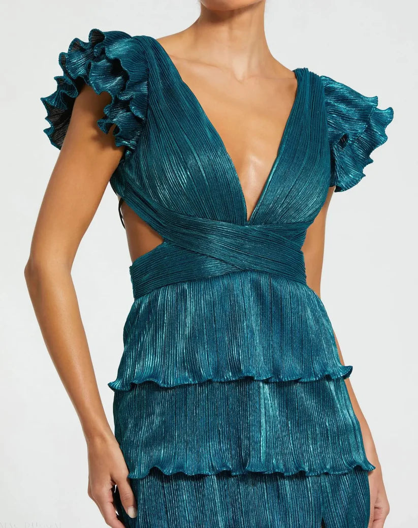 Model wearing Mac Duggal 26740 gown with deep V-neckline, ruffled sleeves, tiered pleated skirt, lace-up back, and thigh-high slit.  Model is wearing the color blue.  Close up picture.