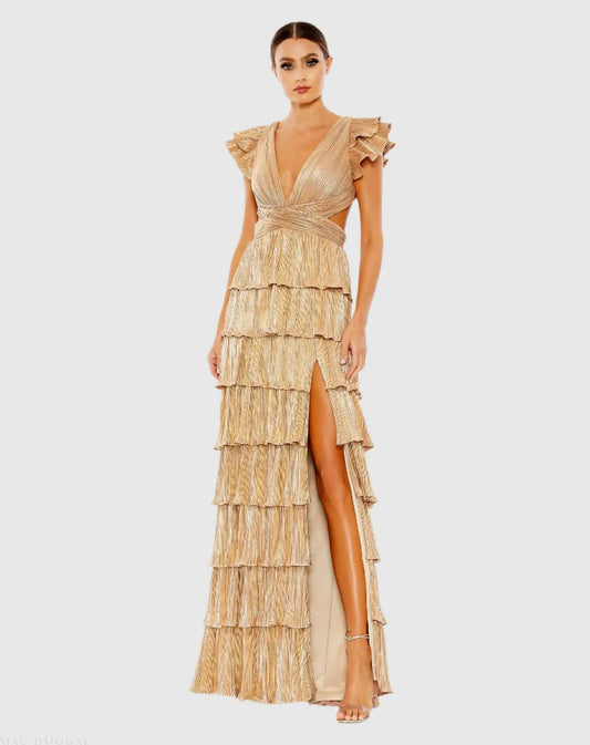 Model wearing Mac Duggal 26740 gown with deep V-neckline, ruffled sleeves, tiered pleated skirt, lace-up back, and thigh-high slit.  Model is wearing the color gold.