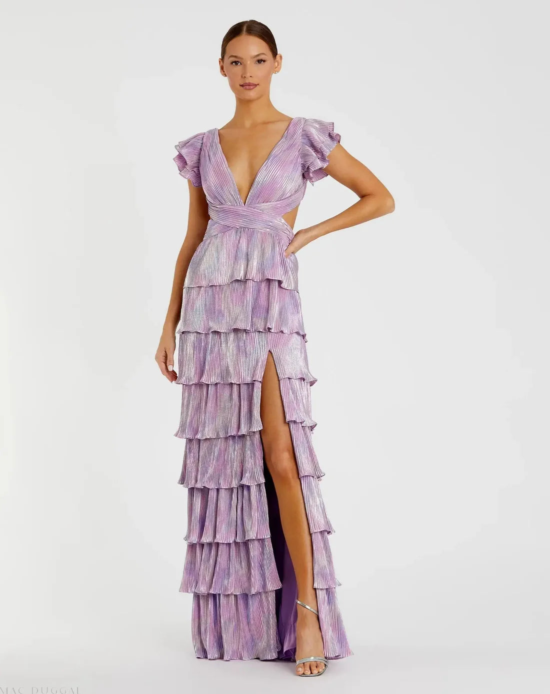 Model wearing Mac Duggal 26740 gown with deep V-neckline, ruffled sleeves, tiered pleated skirt, lace-up back, and thigh-high slit.  Model is wearing the color purple multi.