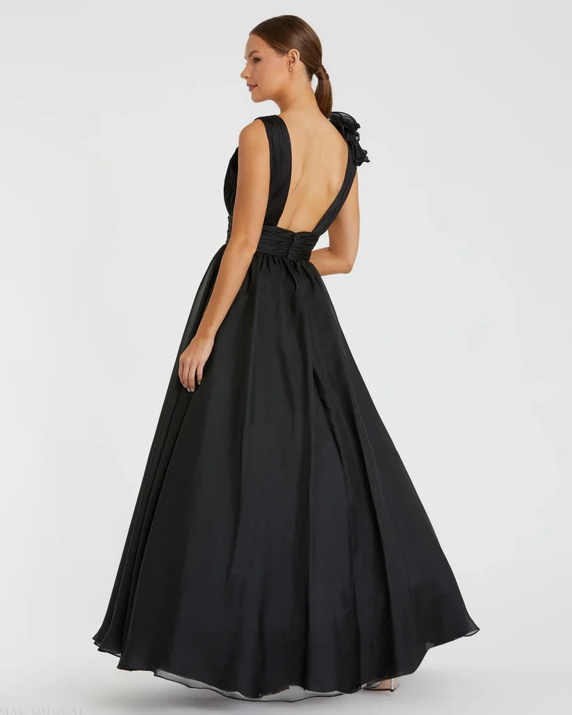 Model wearing Mac Duggal 48856 chiffon gown with V-neckline, ruffle shoulder detail, and flowing skirt.  Model wearing the color black.  Back view.