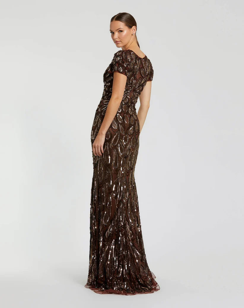 Model wearing Mac Duggal 5243 evening gown with deep V-neckline, cap sleeves, and hand-beaded sequin teardrop pattern.