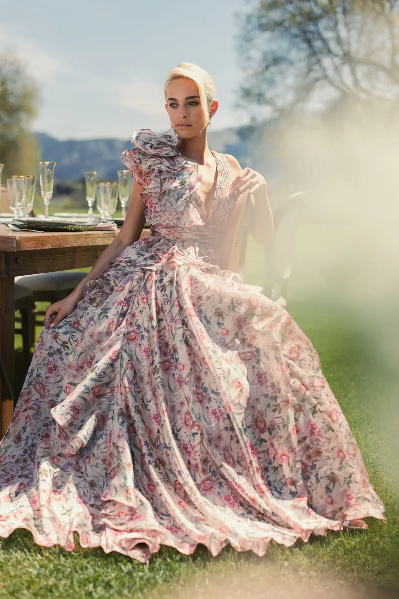 Model wearing Mac Duggal 68947 floral chiffon ballgown with plunging V-neckline, ruffle shoulder detail, and voluminous A-line skirt.  Model is wearing the dress in pinkMulti.  Front view.