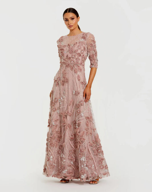 Model wearing Mac Duggal 69016 gown with illusion neckline, 3/4 sheer sleeves, 3D rosettes, and a flowing embellished skirt.  Front View.