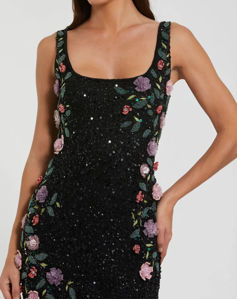 Black dress with floral embellishments on a white background