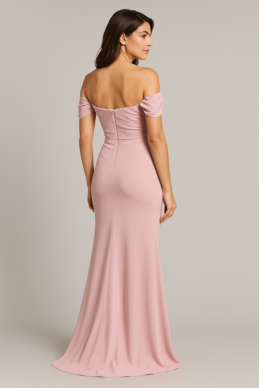 Model wearing Madeline’s Catherine off-shoulder beaded gown with ruched bodice and floor-length skirt.  Model is wearing the dress in the color pink.  Back view.