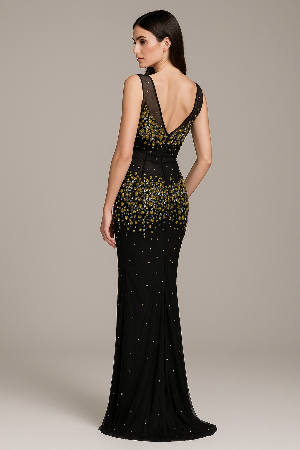 Black evening gown with gold embellishments on a neutral background