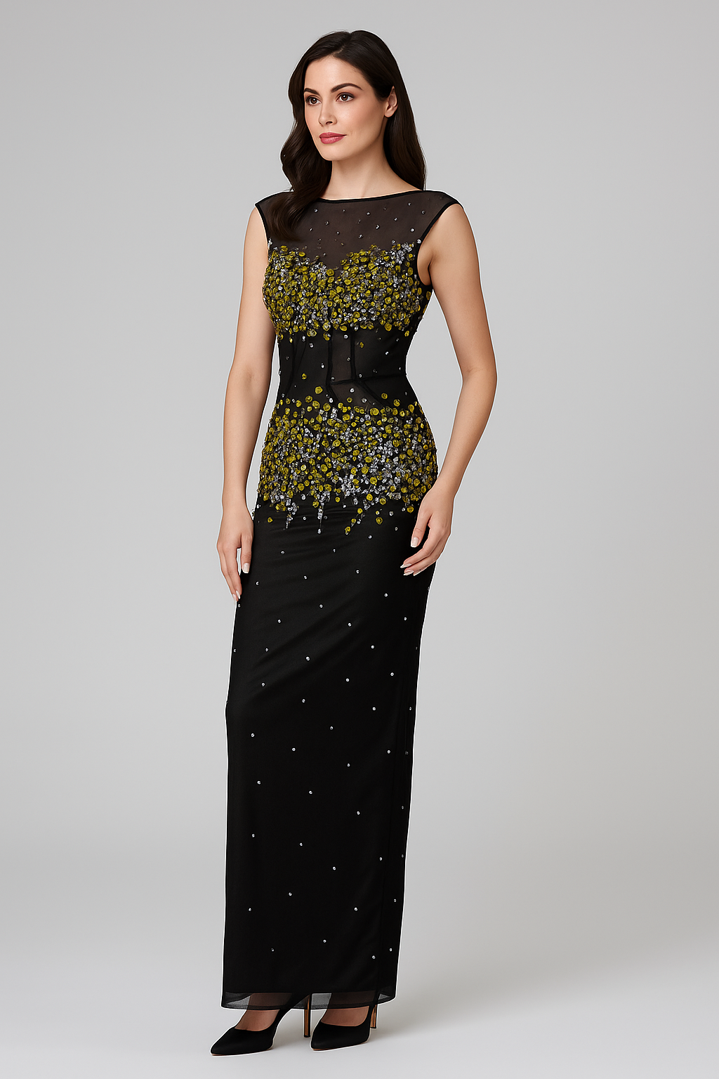 Woman wearing a black evening gown with floral embellishments on a gray background