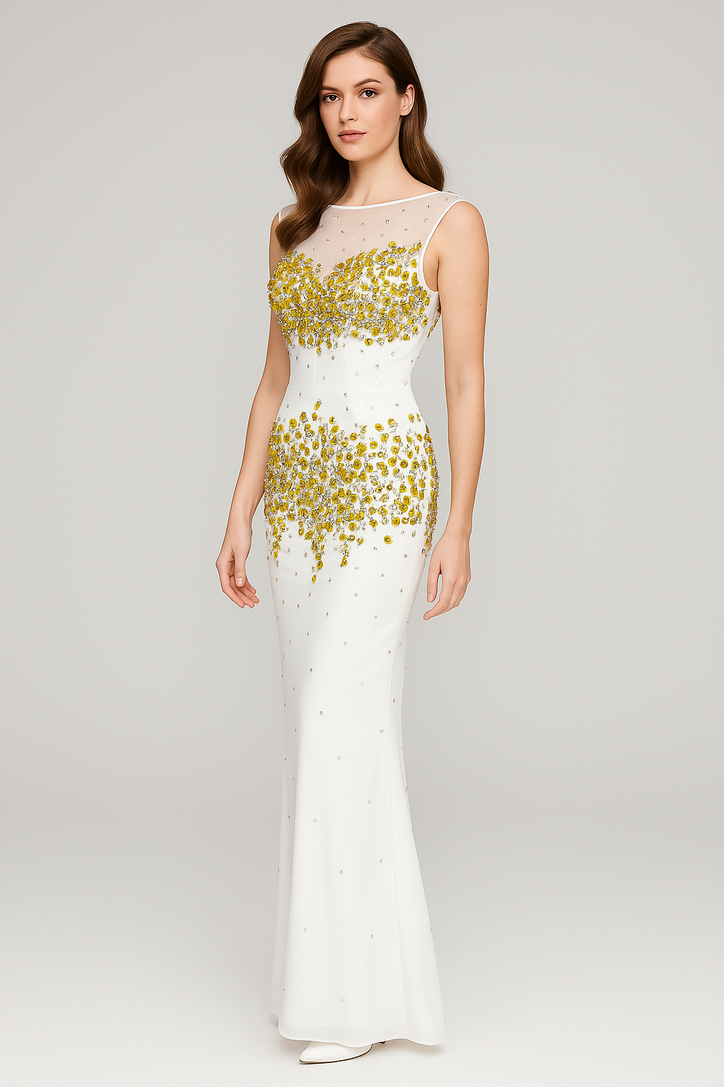 Woman wearing a white evening gown with gold embellishments on a gray background
