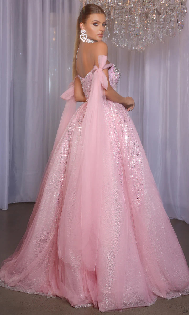 Model wearing Portia & Scarlett PS26030 off-the-shoulder ball gown with embellished corset and full skirt.