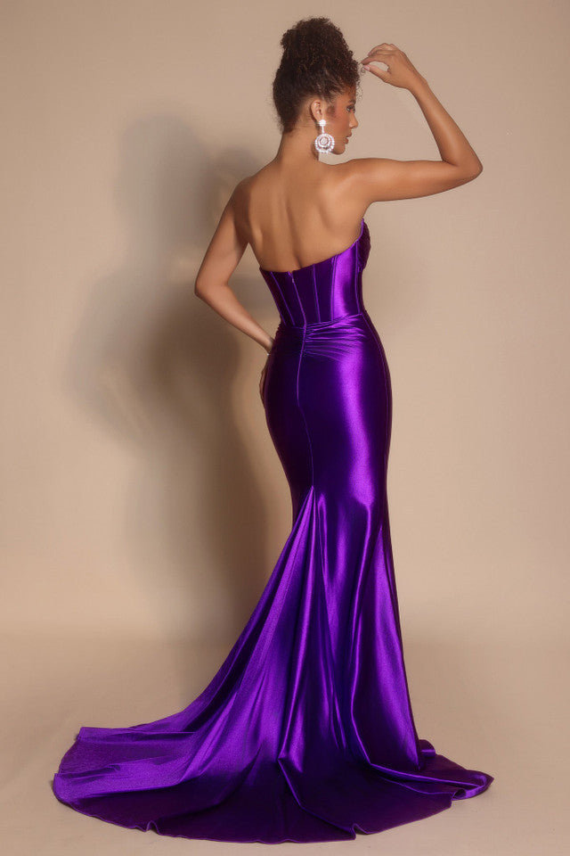 Model wearing the Portia & Scarlett XO080 strapless corset fit-and-flare gown with a structured bodice and floor-length silhouette in the color orchid.