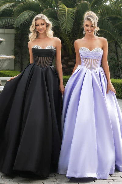 Portia & Scarlett PS25306 Strapless Ballgown featuring an embellished bodice, sheer corset detailing, and a voluminous skirt.