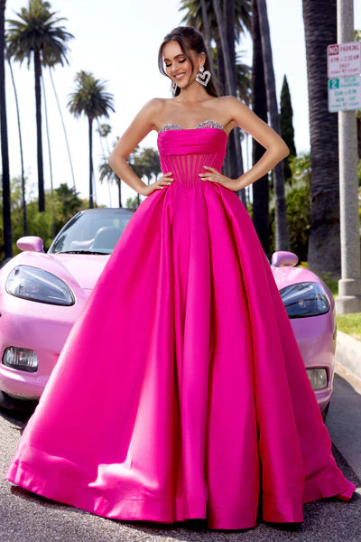 Portia & Scarlett PS25306 Strapless Ballgown featuring an embellished bodice, sheer corset detailing, and a voluminous skirt.
