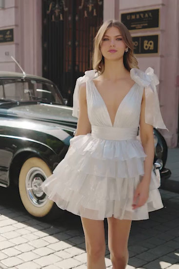 Sherri Hill 56484 Ruffled Cocktail Dress with Bow Sleeves, Plunging V-Neckline in Pearlescent Color. The model is wearing the dress in the color silver.