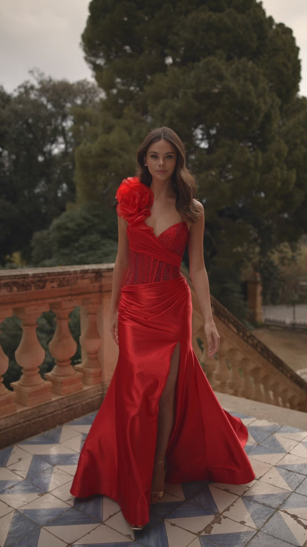 Model wearing Sherri Hill 57475 one-shoulder gown with rosette detail, corset bodice, and draped satin skirt with thigh-high slit.  This is a video.
