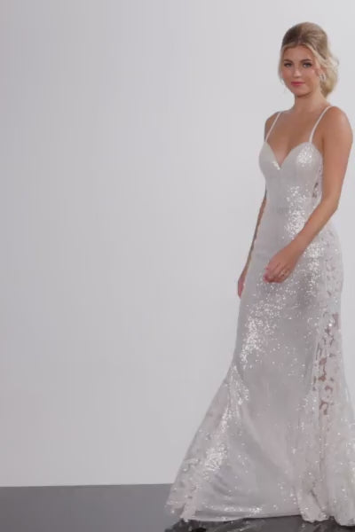 The Jovani Sheer Lace and Sequin Spaghetti Strap Prom Dress, featuring floral details and hot stones on the sheer lace sides, perfect for making a statement at prom.  This is a video of the model wearing the dress.
