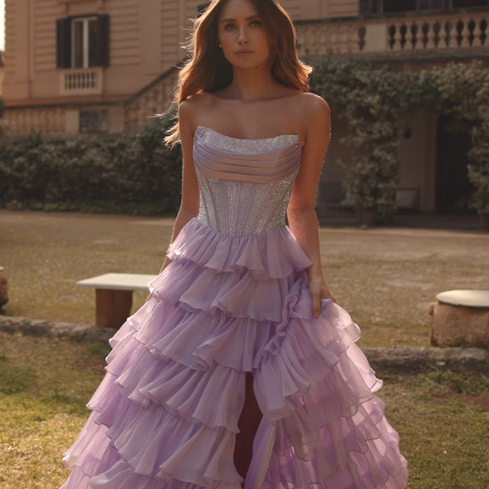 Model wearing Sherri Hill 57288 gown with strapless hot fix corset and layered ruffle slit skirt. This is a video
