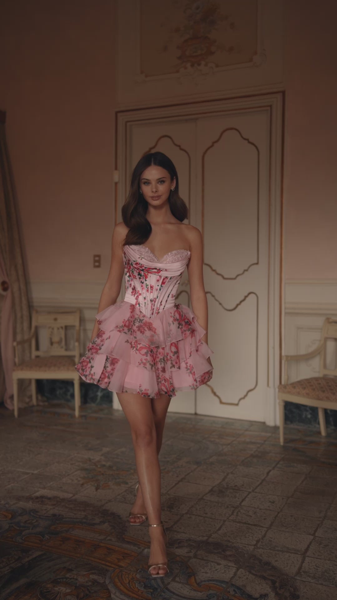 Model wearing Sherri Hill 57296 strapless floral cocktail dress with corset bodice and layered ruffle skirt.  This is a video of the model wearing the dress.