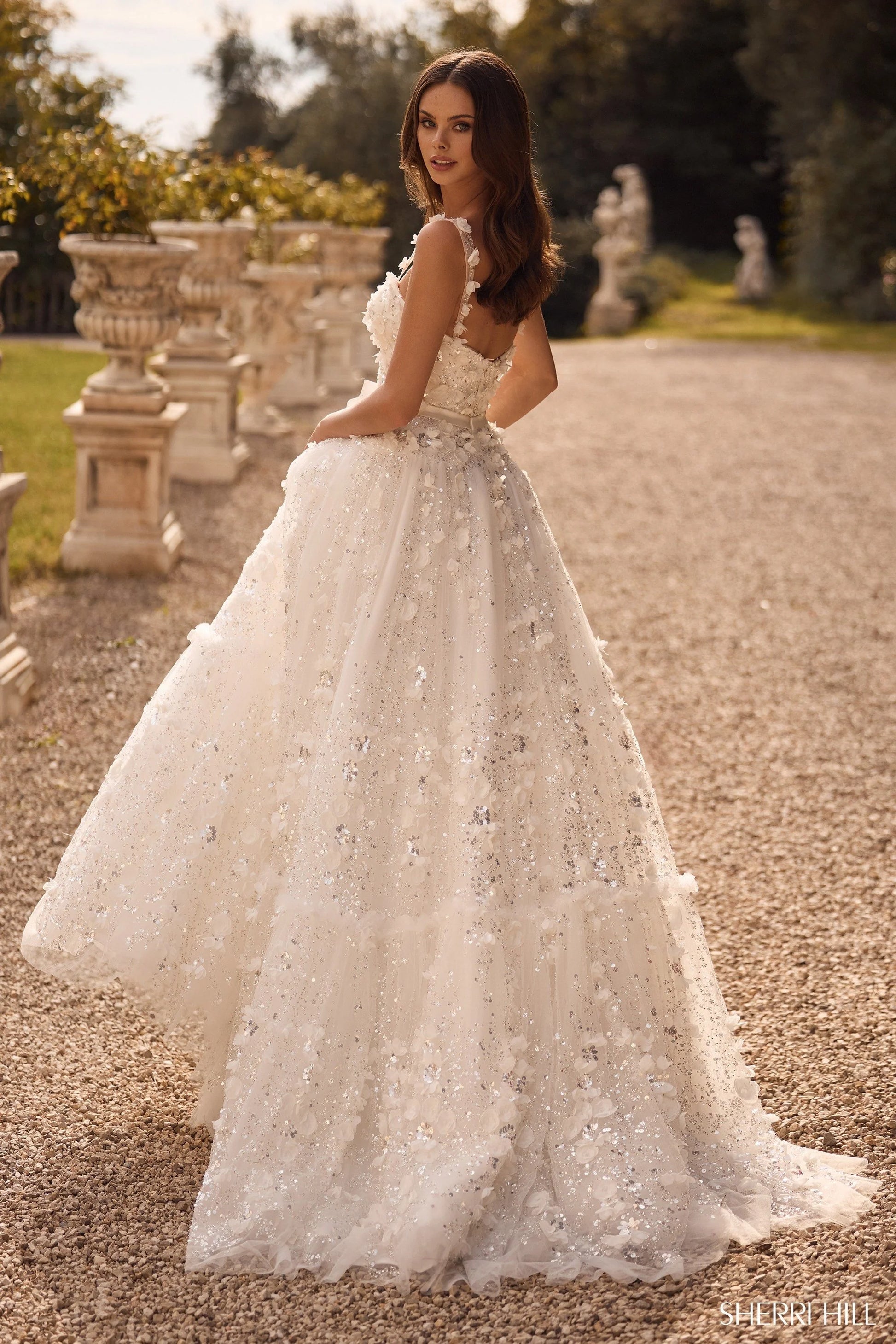 Sherri Hill 57070 3D flower ball gown with sweetheart neckline and ribbon bow waistband, featuring intricate floral appliqués and shimmering embellishments.