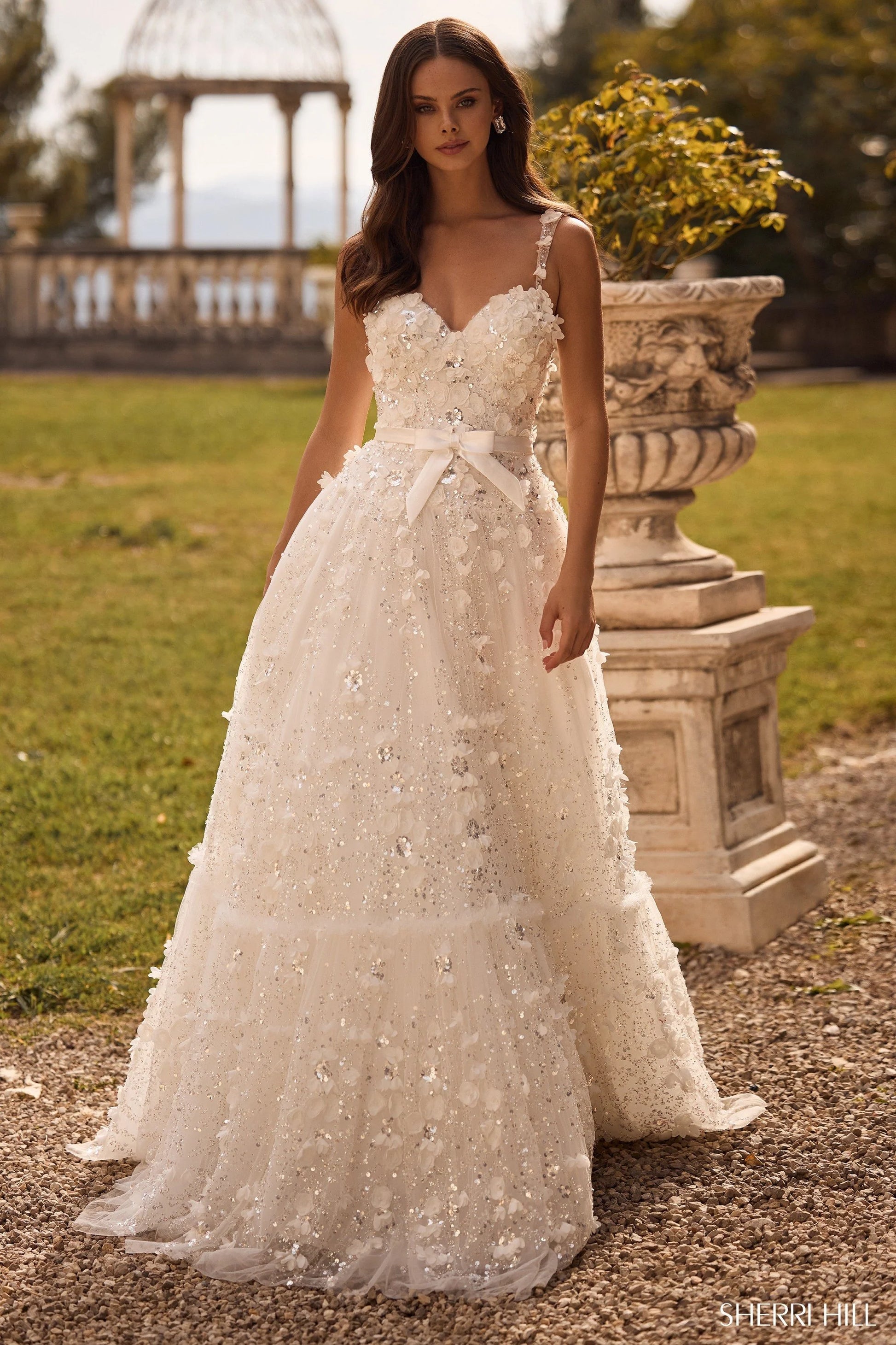 Sherri Hill 57070 3D flower ball gown with sweetheart neckline and ribbon bow waistband, featuring intricate floral appliqués and shimmering embellishments.