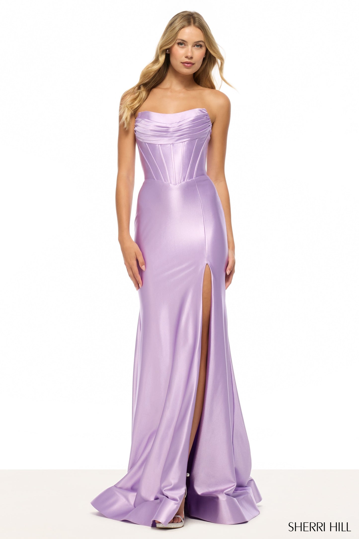 Model wearing Sherri Hill 57412 strapless draped corset gown with high slit and lace-up back.