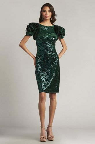 A woman wearing a close-fitting velvet sheath dress with oversized rosette sleeves and intricate paillette embroidery, perfect for elegant evening occasions.