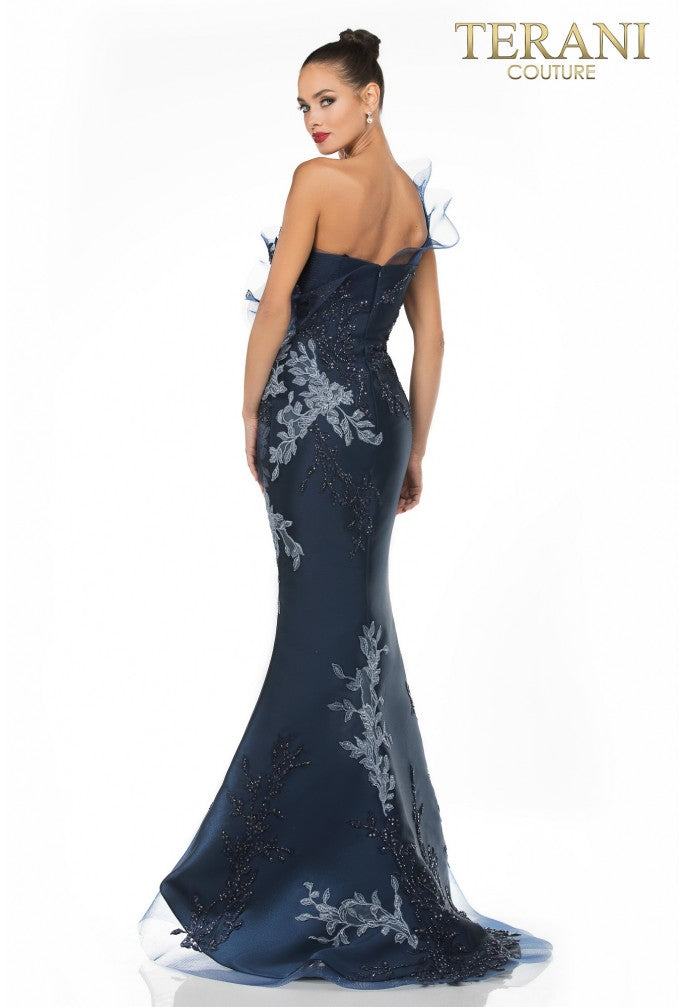 Navy blue evening gown with intricate lace detailing on a white background, featuring the Terani Couture brand.