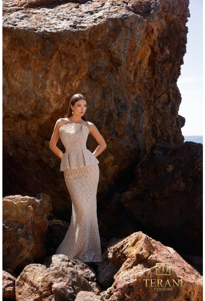 Model wearing Terani Couture 252E5144 strapless lace gown with peplum waist and fit and flare silhouette.
