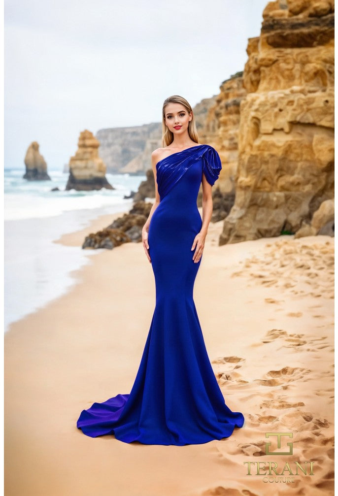 Model wearing Terani Couture 252E5514 one-shoulder gown with puff sleeve, draped bodice, and chapel train in the color royal.  Front View.