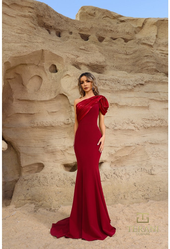 Model wearing Terani Couture 252E5514 one-shoulder gown with puff sleeve, draped bodice, and chapel train in the color wine.