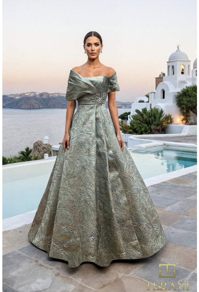 Model wearing Terani Couture 261M6453 off-shoulder A-line gown with textured detailing and embellishment at the waist.