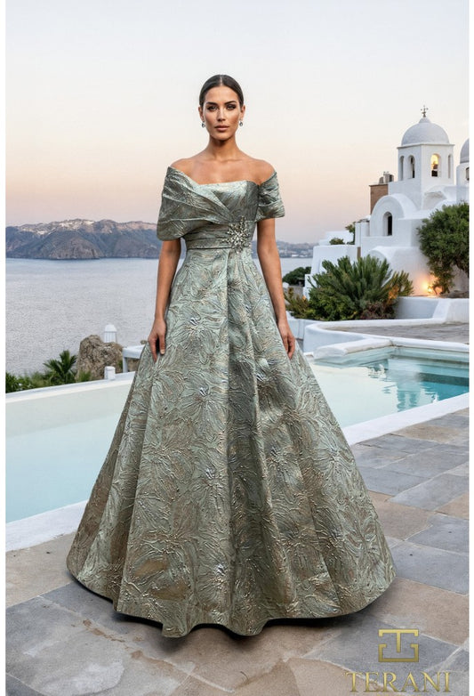 Model wearing Terani Couture 261M6453 off-shoulder A-line gown with textured detailing and embellishment at the waist.