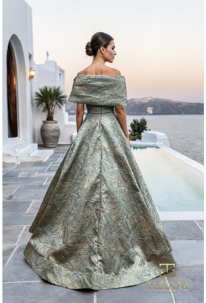 Model wearing Terani Couture 261M6453 off-shoulder A-line gown with textured detailing and embellishment at the waist.