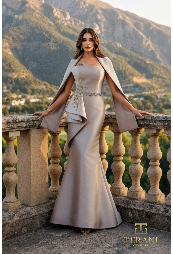 Woman in a elegant dress standing on a balcony with mountains in the background, Terani brand visible.