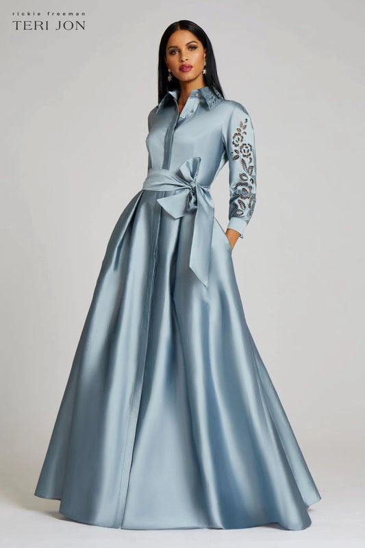 Model wearing Teri Jon 229023 evening gown featuring ¾ sleeves, eyelet embroidered collar and sleeves, and a taffeta A-line skirt.