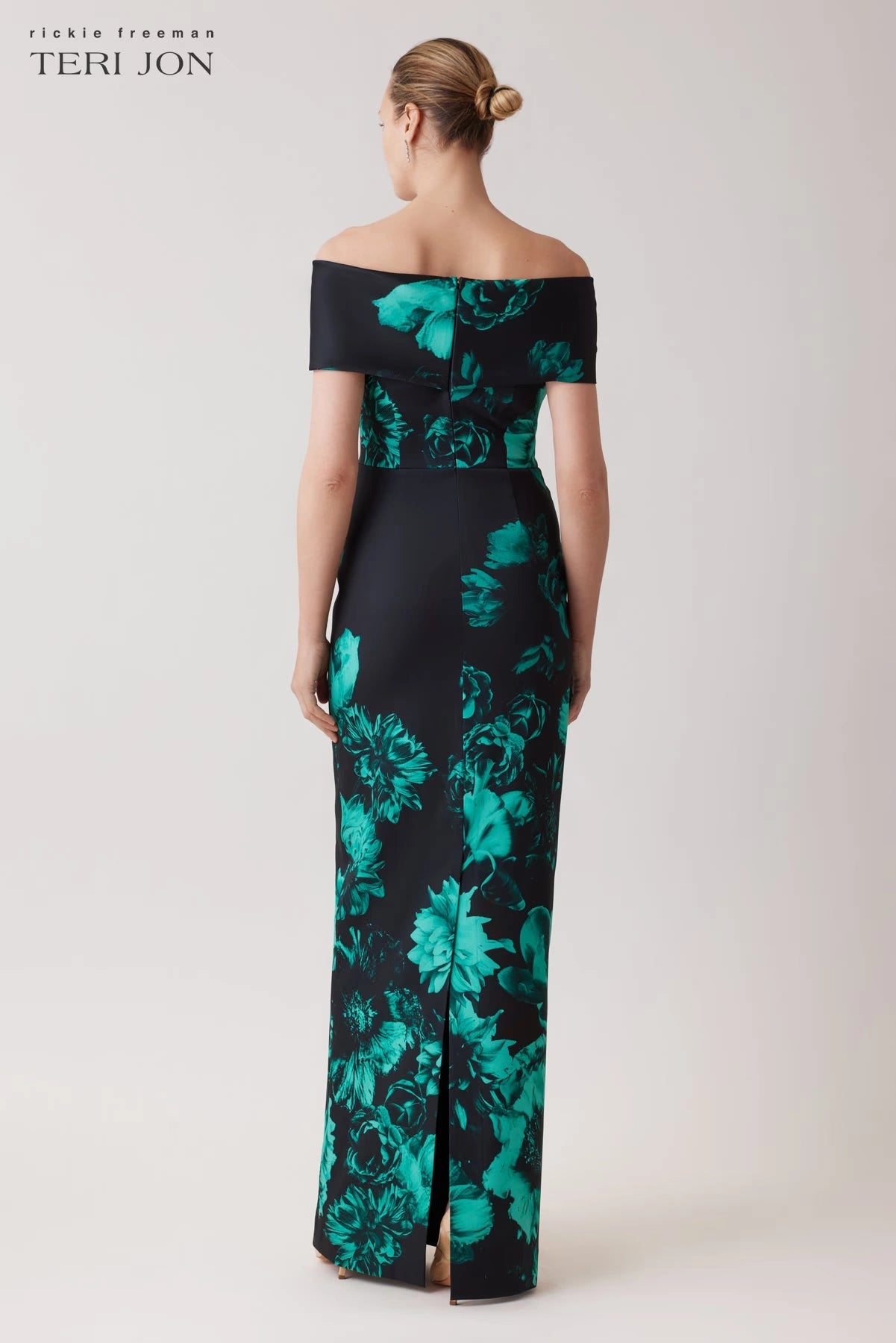 Model wearing Teri Jon 257008 off-the-shoulder column gown with bold floral print, ideal for formal evenings and mother of the bride or groom occasions.