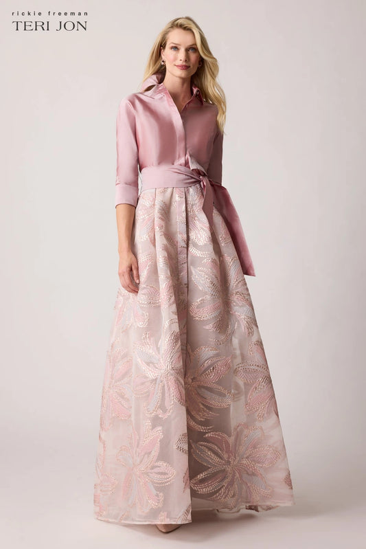 Model wearing Teri Jon 259079 gown featuring a collared neckline, button-up closure, removable sash, and a metallic organza embroidered skirt.